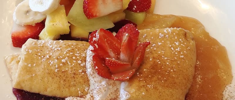 Cheese blintz with applesauce, strawberries and fresh fruit