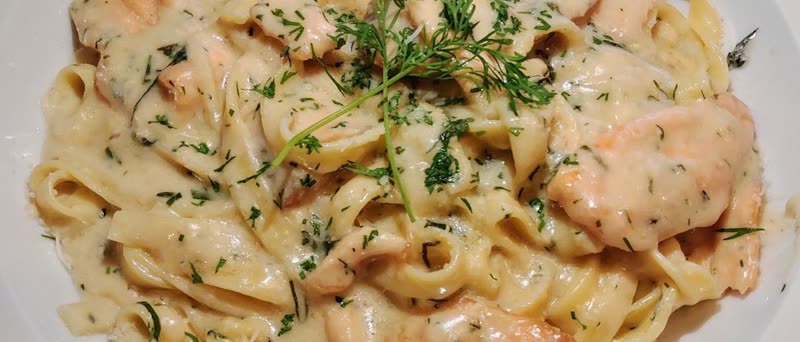 Fettuccine with sauteed salmon in white wine cream sauce